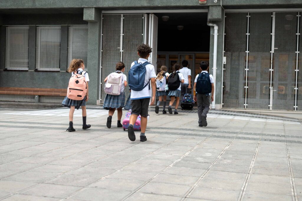 group of primary school children walking into school