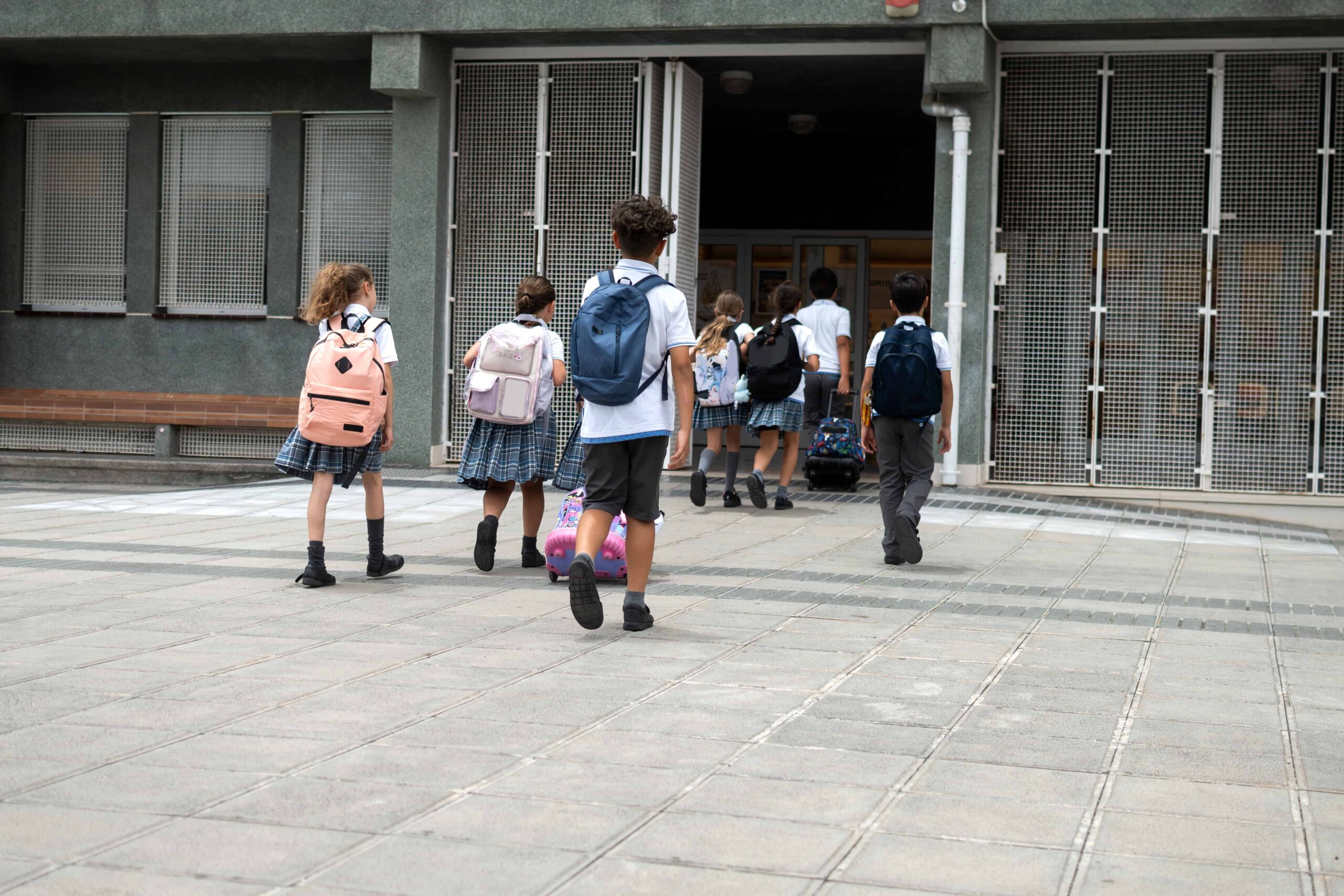 group of primary school children walking into school